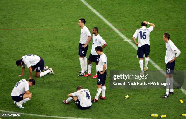 England players show their dejection after the final penalty was scored by Portugal's Cristiano Ronaldo during the Quarter Final match at the FIFA...