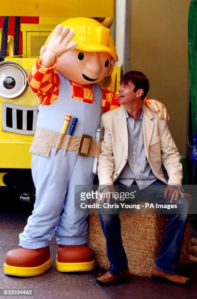 Actor Neil Morrissey greets Bob The Builder, the character that he voices, at the UK premiere of Bob the Builder: Built To Be Wild, in Leicester...