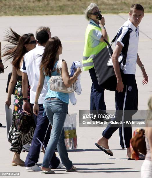 England's Peter Crouch and wives and girlfriends board the plane at Baden Airport, Germany, for the journey back to England. Picture date: Sunday...