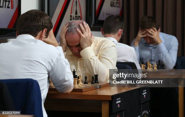 Grandmaster chess player Garry Kasparov concentrates on his next move during his match against grandmaster Levon Aronian in a room with four other...