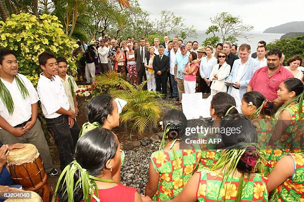 People are gathered in front of the grave of the Belgian singer Jacques Brel , on October 09, 2008 in Atuona on the Marquises islands, part of the...