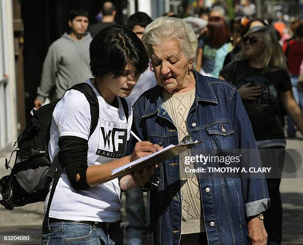 Olivia Mata with the Working Families Party gets a petition signed by Josephine Ferreiro in Astoria, Queens October 9 2008 as part of a campaign to...