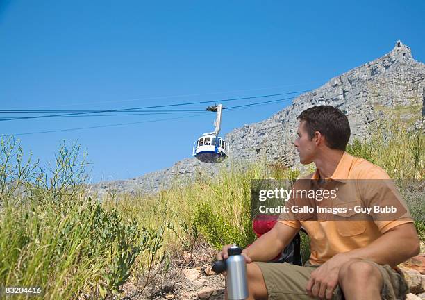 man taking a break from climbing table mountain, cape town, western cape province, south africa - cape town cable car stock pictures, royalty-free photos & images