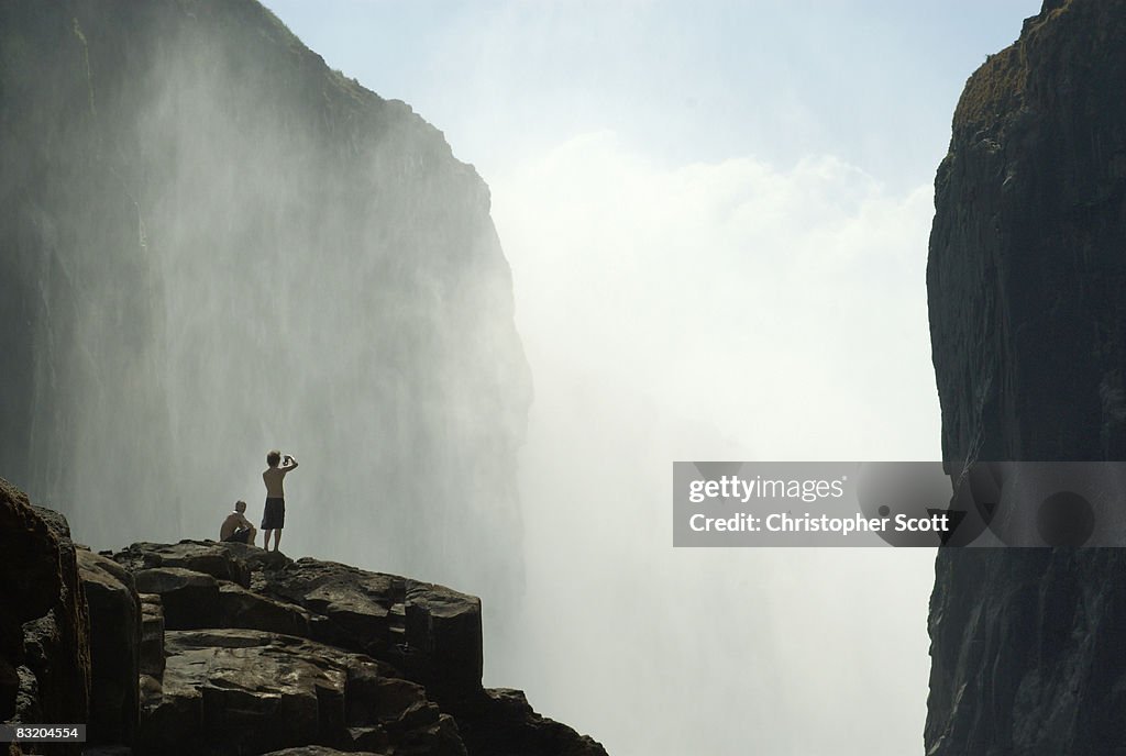 Several kayakers enjoy the view of the Victoria Falls from within the gorge, Victoria Falls, Matabeleland North, Zimbabwe
