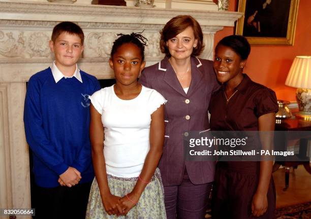 Cherie Blair meets school-children Konrad Trzebiatowski , Lauren Thompson, and Kamika Banton from Croydon, Surrey, when she hosted at tea party for...