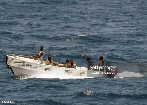 In this handout photograph provided by the U.S. Navy, pirates leave the merchant vessel MV Faina for the Somalia shore under observation by a U.S....