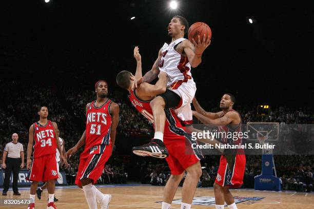 Michael Beasley of the Miami Heat drives into Ryan Anderson during the preseson game part of the 2008 NBA Europe Live Tour on October 9, 2008 at the...