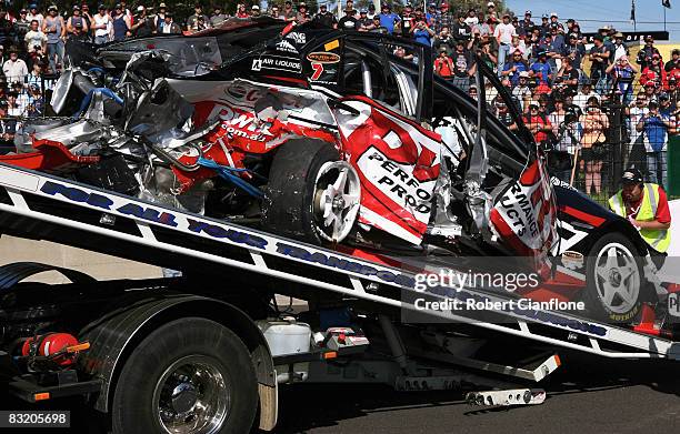 Rescue crews remove the PWR Racing Holden from the track after Paul Weel of PWR Racing crashed with Chris Pither of Team Kiwi Racing during practice...