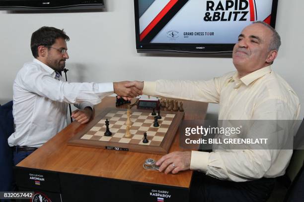 Grandmaster chess player Garry Kasparov shakes the hand of grandmaster Levon Aronian after their match ended in a draw during day two of the Grand...