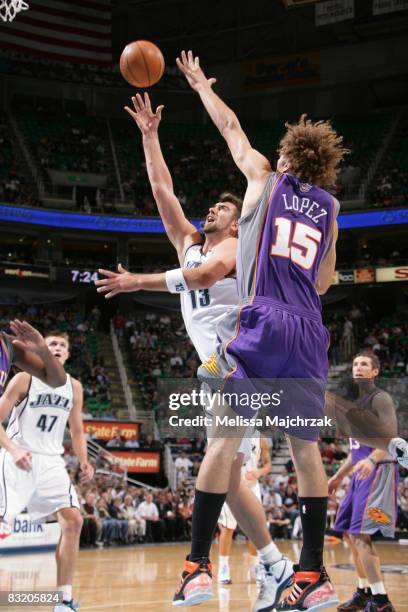 Mehmet Okur of the Utah Jazz shoots over Robin Lopez of the Phoenix Suns at EnergySolutions Arena on October 09, 2008 in Salt Lake City, Utah. NOTE...