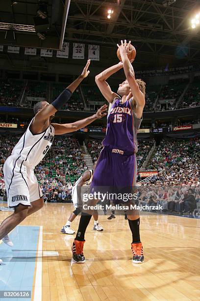 Robin Lopez of the Phoenix Suns shoots over Jerron Collins of the Utah Jazz at EnergySolutions Arena on October 09, 2008 in Salt Lake City, Utah....