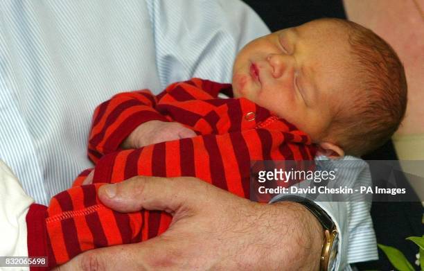James Fraser Brown is held by his father Chancellor Gordon Brown, outside Edinburgh Royal Infirmary.