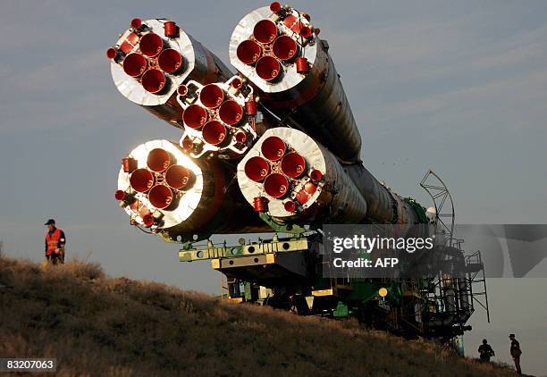 Russian soldiers guard the SOYUZ TMA-13 rocket as it is transported to the launch pad of the Russian leased Baikonur cosmodrome, in Kazakhstan, on...