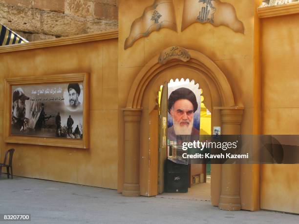 Photo of Iran's Ayatollah Khomeini is seen inside a makeshift exhibition hall with a displayed banner outside with photo of Hassan Nasrollah and...