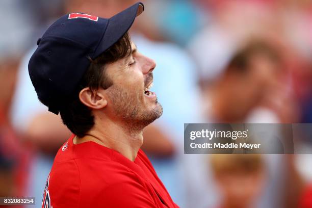 Actor Casey Affleck laughs before throwing out the first pitch at Fenway Park before the game between the Boston Red Sox and the St. Louis Cardinals...