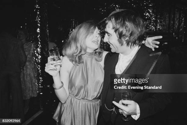 British drummer Keith Moon with American beauty queen Joyce McKinney at 'Saturday Night Fever' film premiere, London, UK, 23rd March 1978.