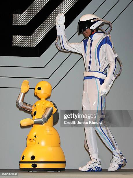 Mitsubishi Heavy Industries' robot Wakamaru copies the movement of a man wearing sensor tubes on his body during the Robo_Japan 2008 Press Preview at...