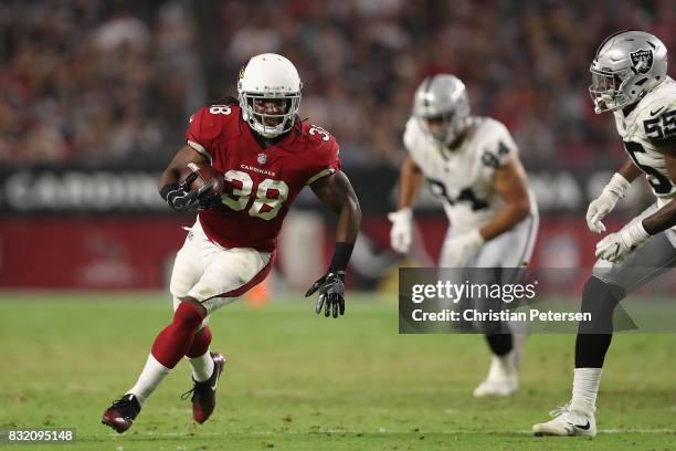 Running back Andre Ellington of the Arizona Cardinals rushes the football against the Oakland Raiders during the NFL game at the University of...