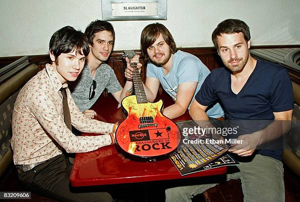 Members of the band Panic at the Disco guitarist Ryan Ross, frontman Brendon Urie, drummer Spencer Smith, and bassist Jon Walker pose with an...