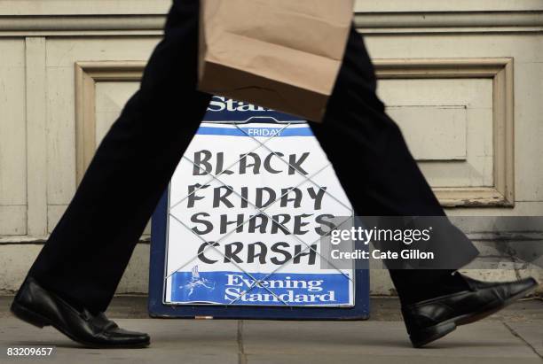 City worker passes the Evening Standard headline board showing the words 'Black Friday Shares Crash' during lunch time on Friday on October 10, 2008...