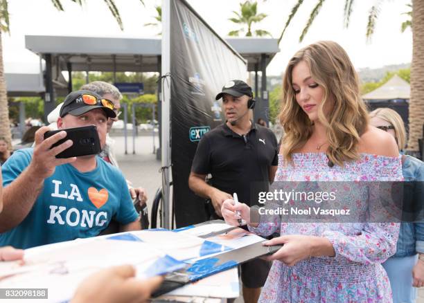 Lili Simmons takes a selfie with a fan at "Extra" at Universal Studios Hollywood on August 15, 2017 in Universal City, California.