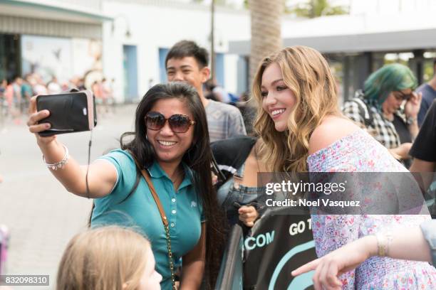 Lili Simmons takes a selfie with a fan at "Extra" at Universal Studios Hollywood on August 15, 2017 in Universal City, California.