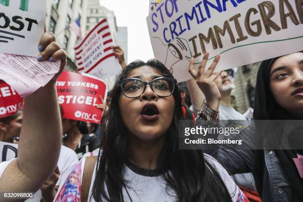 Demonstrators hold signs and chant during the "Defend DACA & TPS" rally outside of Trump Tower in New York, U.S., on Tuesday, Aug. 15, 2017. A day...