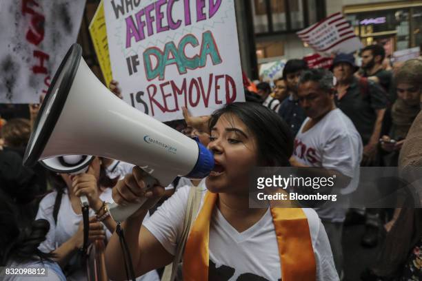 Demonstrator shouts into a megaphone during the "Defend DACA & TPS" rally outside of Trump Tower in New York, U.S., on Tuesday, Aug. 15, 2017. A day...