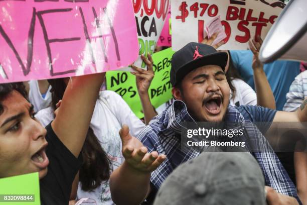 Demonstrators hold signs and chant during the "Defend DACA & TPS" rally outside of Trump Tower in New York, U.S., on Tuesday, Aug. 15, 2017. A day...