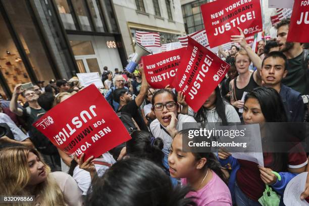 Demonstrators hold signs and chant during the "Defend DACA & TPS" rally outside of Trump Tower in New York, U.S., on Tuesday, Aug. 15, 2017. A day...