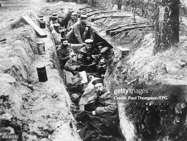 German soldiers read newspapers in their trench during a lull in the fighting at the Fourth Battle of Ypres, October 1918.