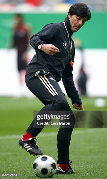 Coach Joachim Loew stopps a ball during a German national team training session on October 10, 2008 in Duesseldorf, Germany.