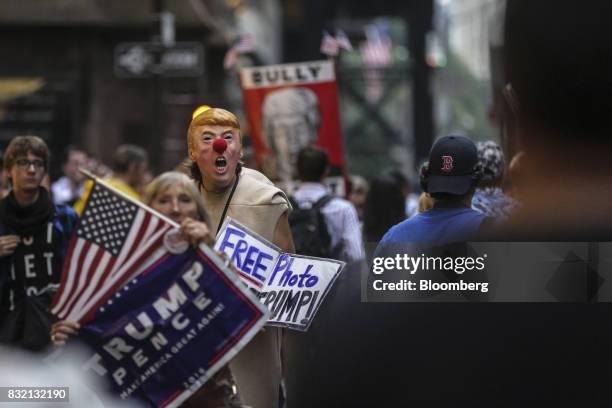 Demonstrator wears a mask in the likeness of U.S. President Donald Trump during the "Defend DACA & TPS" rally outside of Trump Tower in New York,...