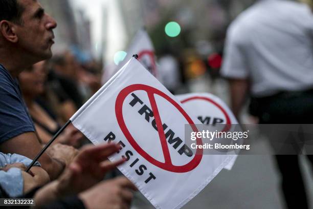 Demonstrators hold flags during the "Defend DACA & TPS" rally outside of Trump Tower in New York, U.S., on Tuesday, Aug. 15, 2017. A day after...