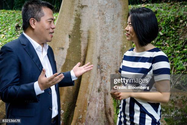Billionaire Chen Tianqiao, founder and chairman of Shanda Group, left, speaks to his wife Chrissy Luo, co-founder and vice chairman, while standing...