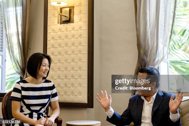 Billionaire Chen Tianqiao, founder and chairman of Shanda Group, right, speaks as his wife Chrissy Luo, co-founder and vice chairman, looks on during...