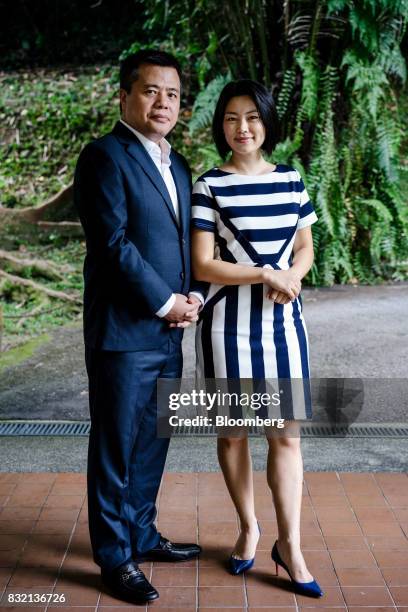 Billionaire Chen Tianqiao, founder and chairman of Shanda Group, left, and his wife Chrissy Luo, co-founder and vice chairman, pose for a photograph...