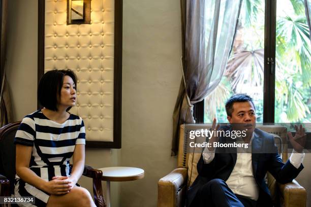 Billionaire Chen Tianqiao, founder and chairman of Shanda Group, right, speaks as his wife Chrissy Luo, co-founder and vice chairman, looks on during...