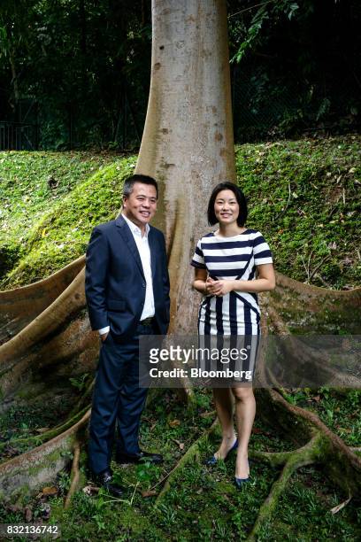 Billionaire Chen Tianqiao, founder and chairman of Shanda Group, left, and his wife Chrissy Luo, co-founder and vice chairman, pose for a photograph...