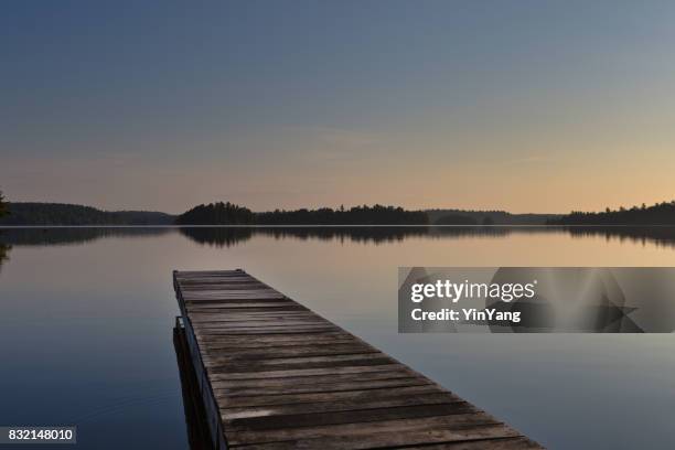 lake scene  and boat dock at ely, boundary water canoe area, minnesota, usa at sunrise - ely stock pictures, royalty-free photos & images