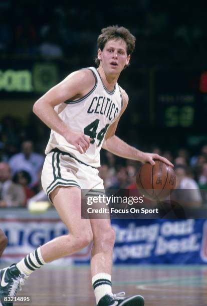 S: Danny Ainge of the Boston Celtics brings the ball up court during a circa 1980's NBA basketball game at the Boston Garden in Boston,...