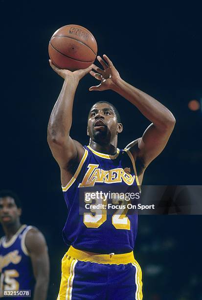 S: Ervin Magic Johnson of the Los Angeles Lakers shoots a free-throw against the New Jersey Nets during a circa 1980's NBA basketball game at the...