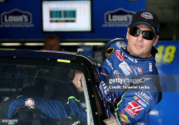 Jimmie Johnson, driver of the Lowe's Chevrolet, gets into his car before the start of practice for the NASCAR Sprint Cup Series Bank of America 500...