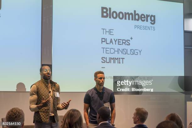 Andre Iguodala, a professional basketball player with the National Basketball Association's Golden State Warriors, left, speaks while Stephen Curry,...
