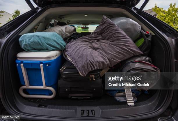 car truck packed with luggage and other items for road trip - luggage trunk stock-fotos und bilder