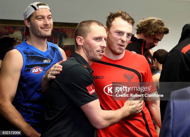 James Kelly of the Bombers is hugged by teammate Brendon Goddard after a press conference to announce his retirement at the Essendon Football Club on...