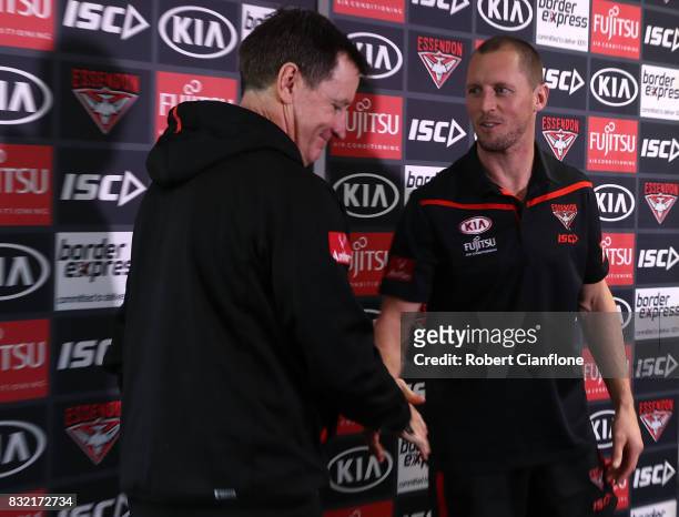 James Kelly of the Bombers shakes hands with Bombers coach John Worsfold during a press conference to announce his retirement at the Essendon...