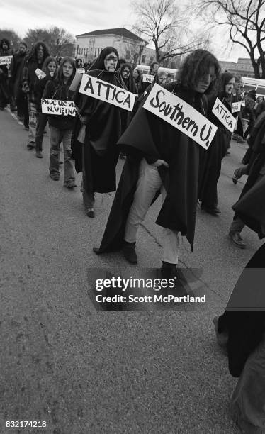 Washington, DC : Hundreds of young activists dressed in black, and holding signs march in Washington, DC protesting the Vietnam War, and Richard...