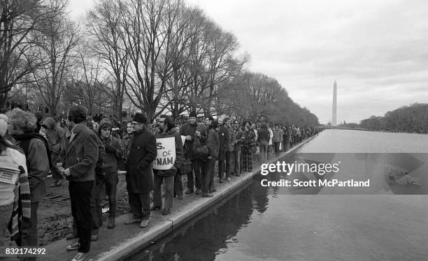 Washington, DC : Large groups of activists line up next to the Lincoln Memorial Reflecting Pool in Washington, DC in protest of the Vietnam War, and...