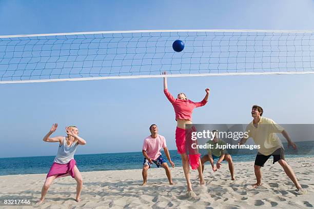 friends playing beach volleyball - beach volleyball spike stock pictures, royalty-free photos & images